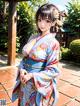 A woman in a blue kimono posing for a picture.